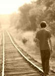 Teen Boy on Railroad Tracks